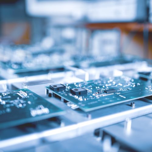 Close-up computer green microcircuits lie row after row in the industrial production of computers and office equipment. Concept of developing new technologies and storing information